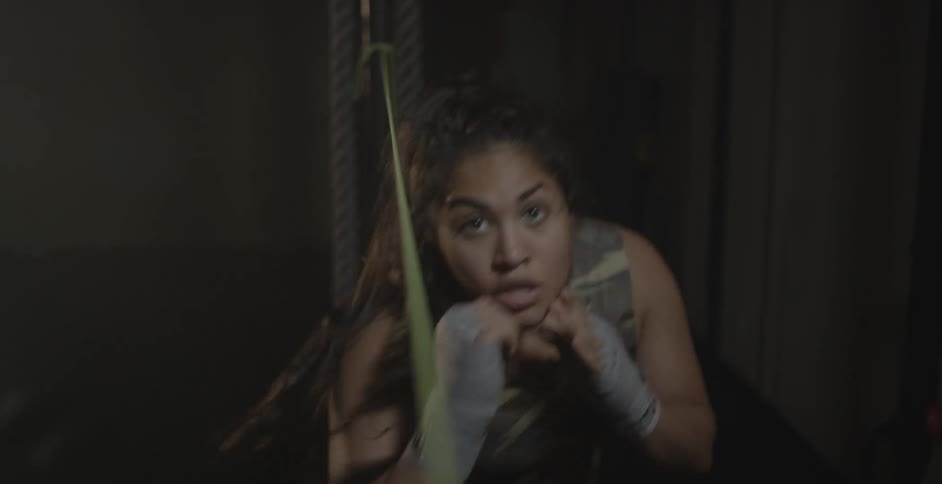 A woman punches and weaves under a string
