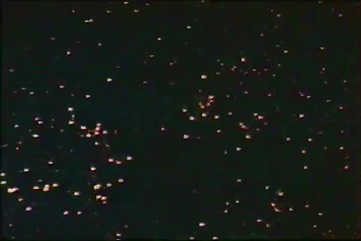 Vintage footage shows a colorful fireworks display exploding in the night sky