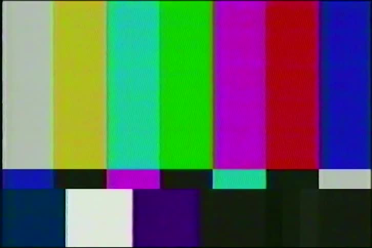 A retro television screen displays a classic color bars test pattern with analog VHS distortion, static, and glitch effects