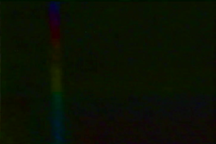 Authentic VHS tape damage with a vibrant rainbow tracking line, static, and heavy noise