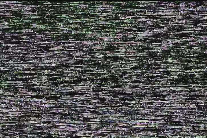 An authentic, looping close-up of analog television static with flickering noise and color glitches