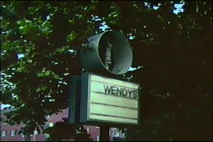 Vintage home video footage of a classic Wendy's fast-food restaurant drive-thru sign from the 1980s