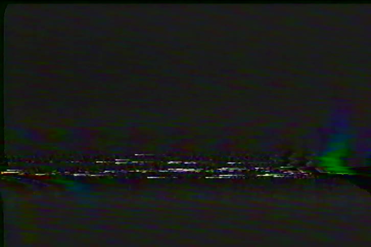 Authentic analog VHS tape noise and static with colorful glitches and tracking errors