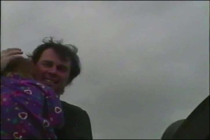 Authentic home movie footage from the 1990s shows a young boy in a Bulls sweatshirt and a father lovingly hugging his daughter