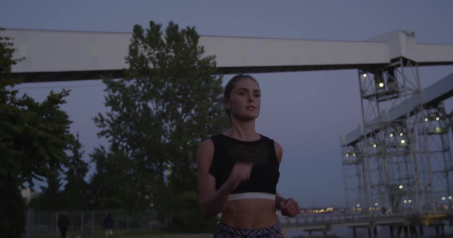 Woman jogging outside at sunset