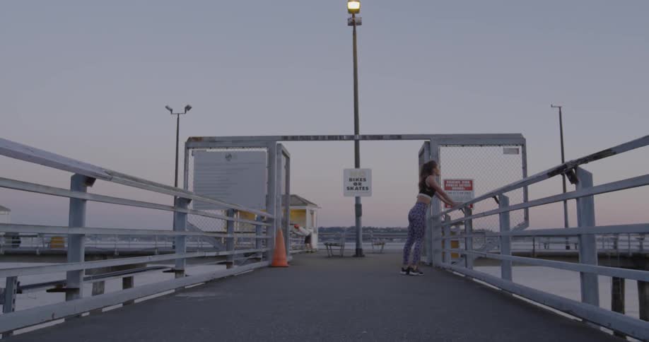 Woman resting on a rail on a pier