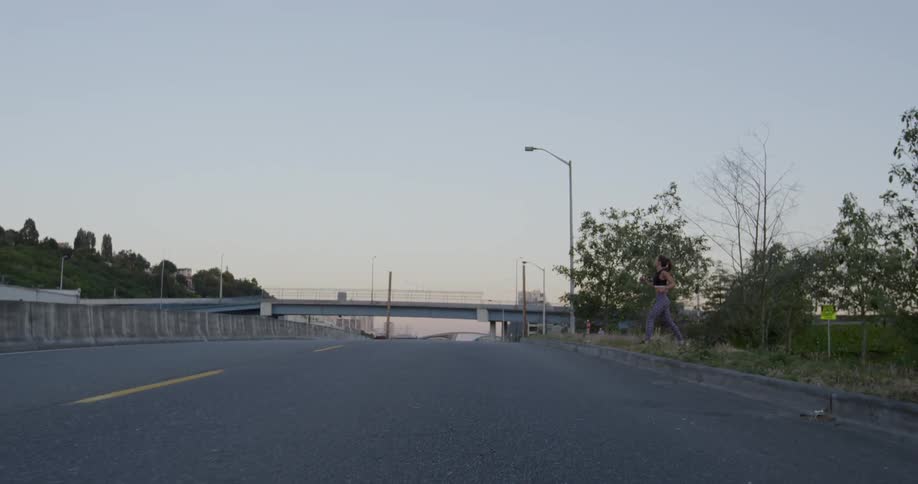 A woman runs over to the side of the road