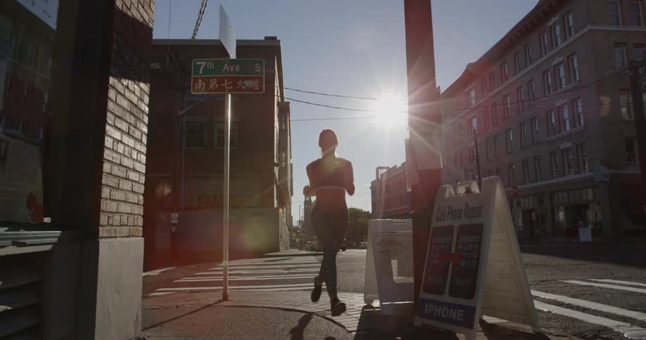 A woman jogs down the street in town