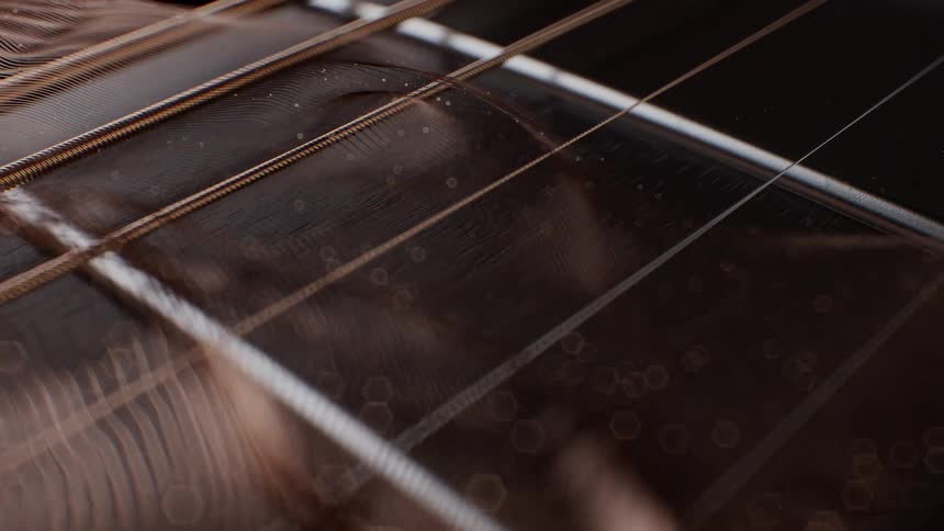 An extreme close-up, slow-motion shot of a vibrating acoustic guitar string with a soft, artistic bokeh overlay