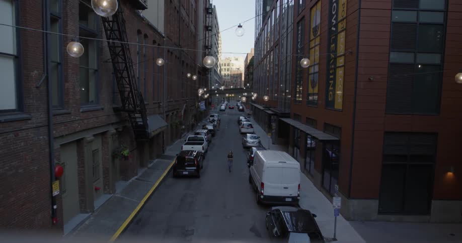 A woman jogs down a city street