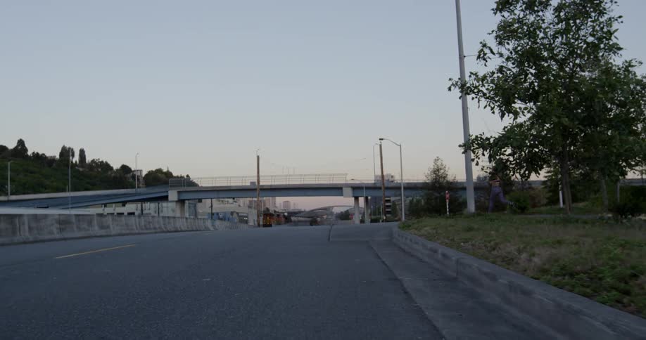 A woman jogs and takes a rest next to the street