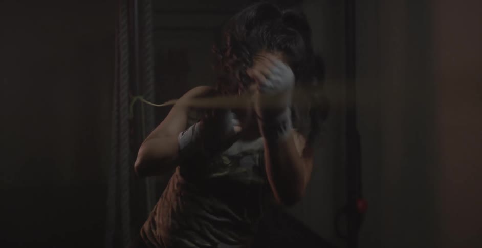 A woman is bobbing and weaving under a rope