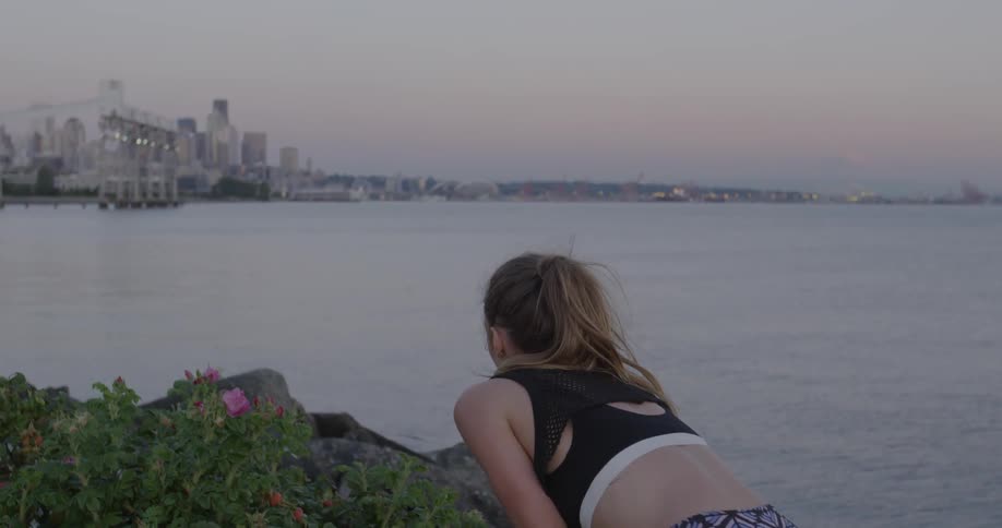 A woman takes a rest next to a river