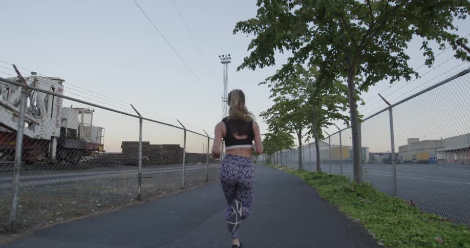 A woman jogs down the street