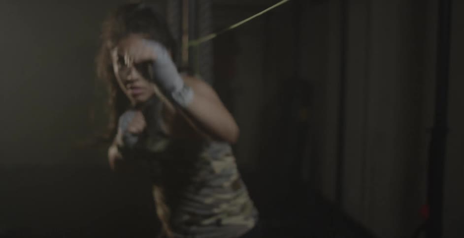 A woman boxer trains in a gym