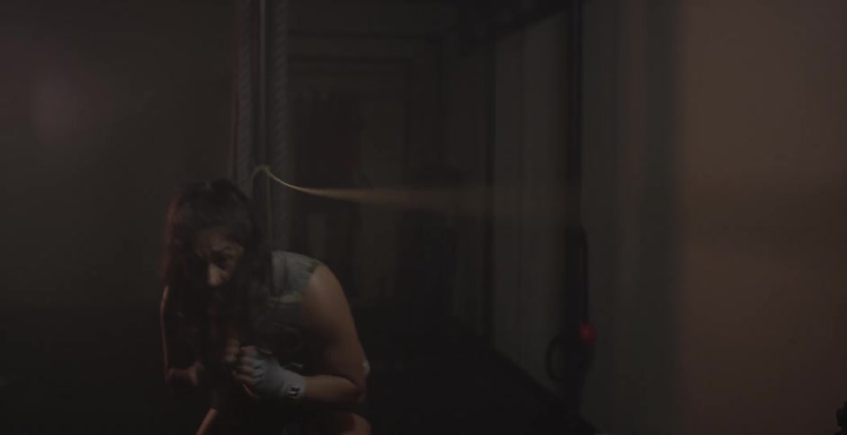 A woman punches on both sides of a string
