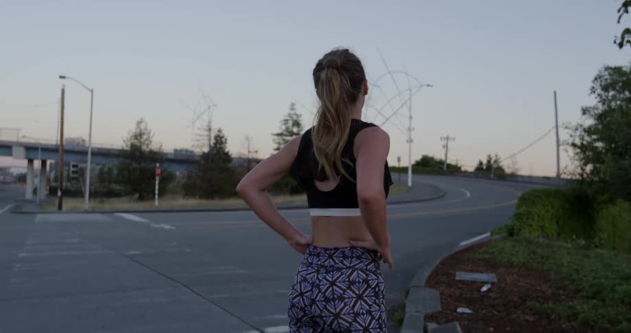 A woman takes a rest next to a city road