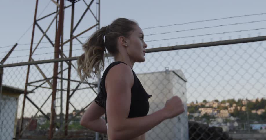 A woman is running outside on a sunny day