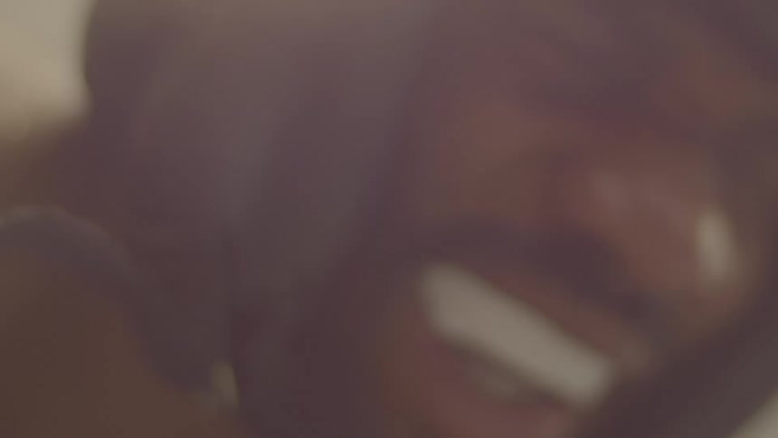 An abstract and out-of-focus close-up shot of a man in a hoodie as he moves