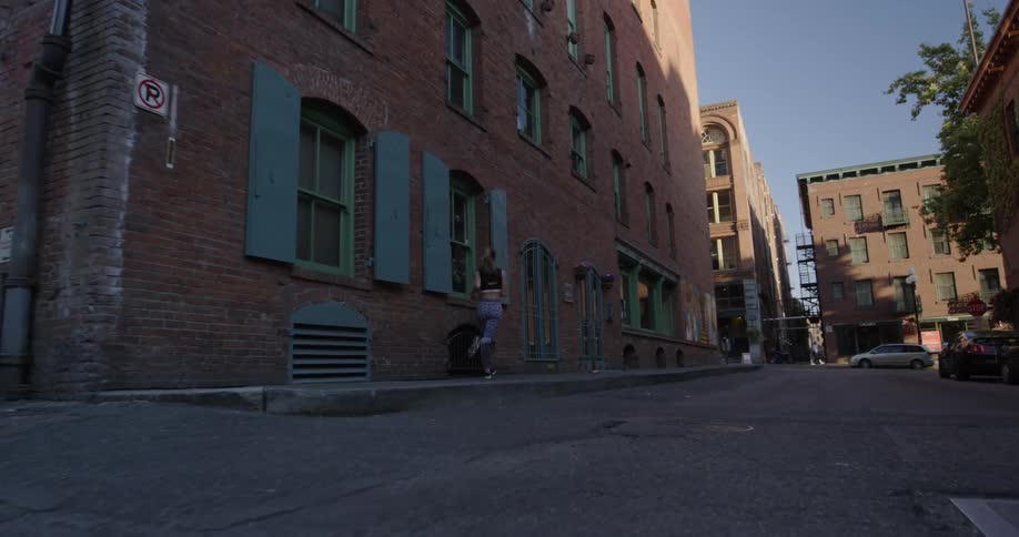 A woman jogs through the city