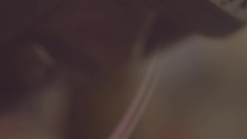 An extremely blurry, out-of-focus, and shaky close-up of an unidentifiable person or object