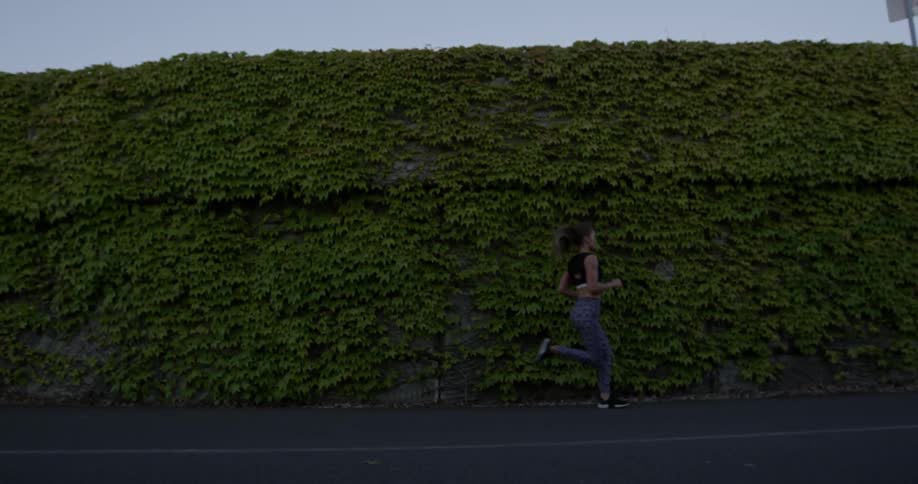 A woman jogs down the street