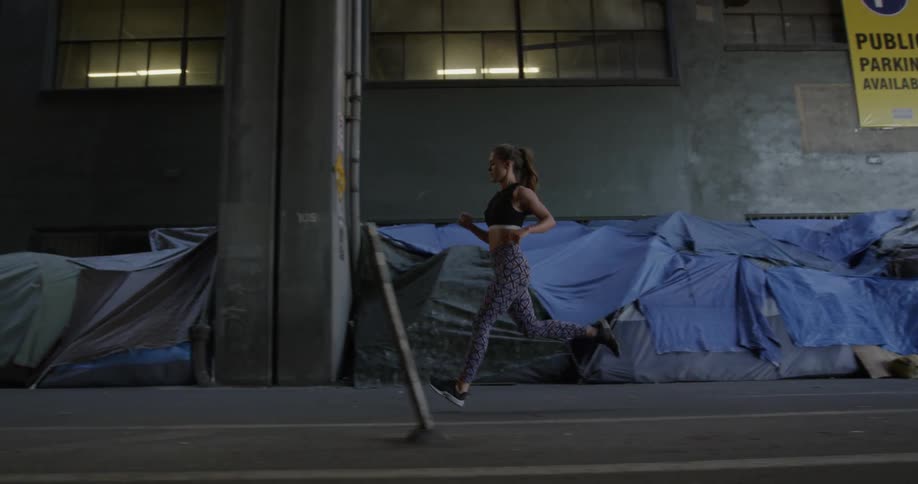 Woman jogging in a city in an industrial area
