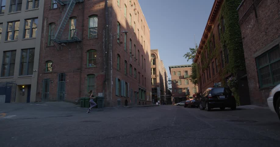 A woman jogs on a city street