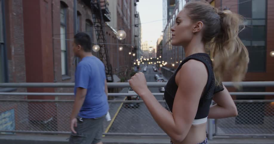 A woman jogs through the city