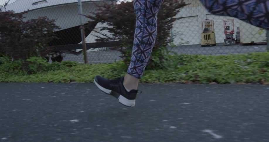 A woman jogs down the street