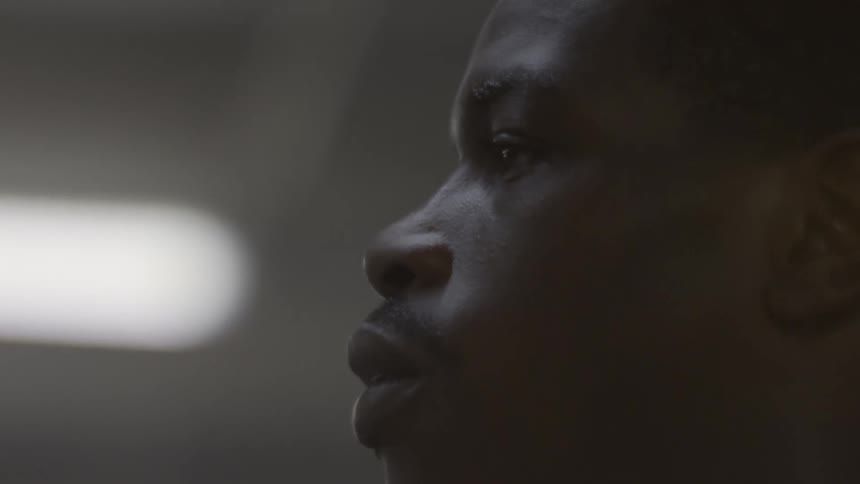 Dramatic close-up profile of a man breathing with intensity in a dimly lit room