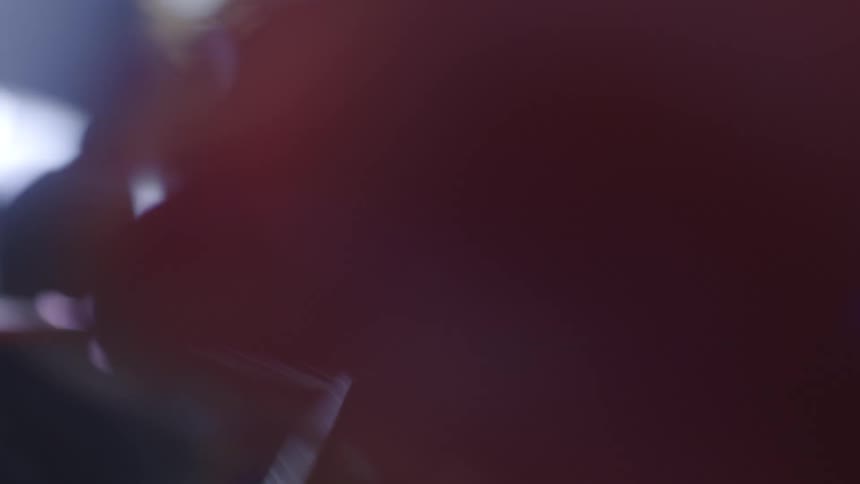 An intense point-of-view shot captures a boxer throwing rapid-fire punches at the camera, creating bright lens flares