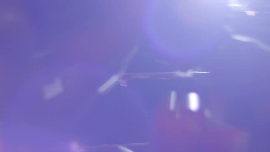 Intense close-up of two boxers sparring in a ring, captured in slow motion with dramatic lens flares