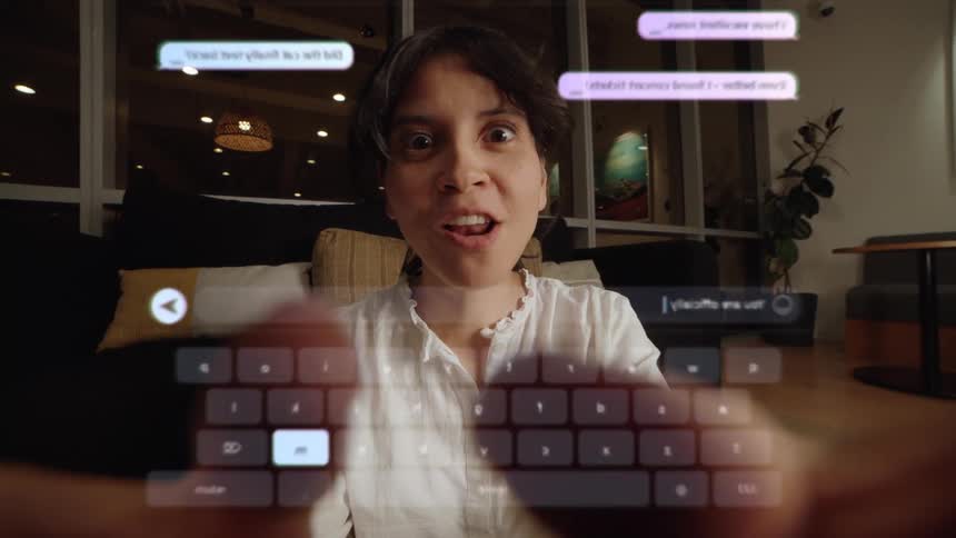 A smiling woman types on a futuristic AR keyboard, her expression changing to surprise as she interacts with the virtual chat