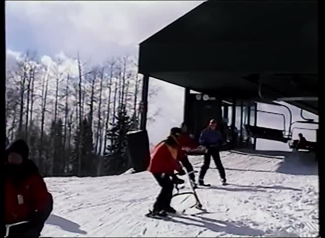 Vintage footage shows adaptive skiers waiting by the chairlift on a snowy mountain