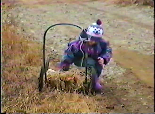 Nostalgic home video from the 1990s shows a little girl in winter gear playing with and pushing a homemade hay-filled wagon