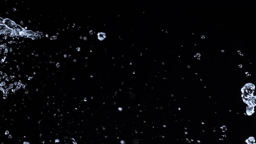 Mesmerizing super slow motion footage of water droplets cascading and splashing against a stark black background