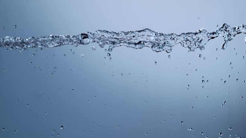 A clear jet of water flows and splashes in super slow motion against a clean, neutral background