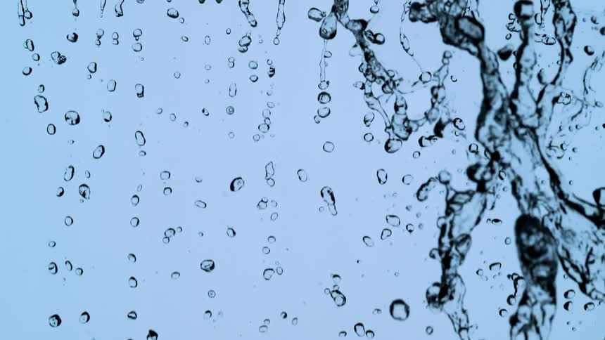 A stunning slow-motion macro shot of clear water droplets and streams cascading against a clean light blue background