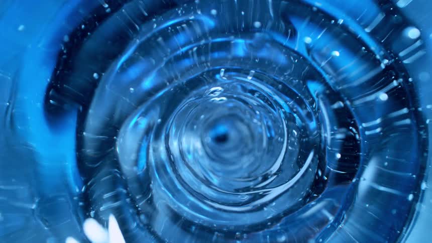 Mesmerizing blue liquid forms a swirling vortex, creating a tunnel-like illusion