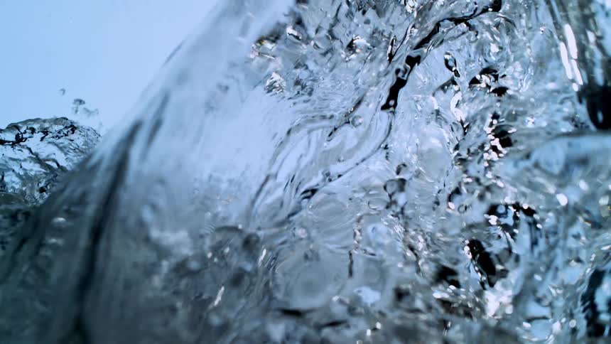 Crystal clear water forms a powerful, beautiful wave and crashes in extreme slow motion
