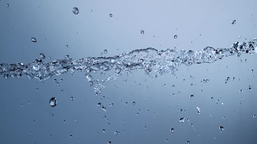 An elegant stream of crystal clear water flows horizontally, creating beautiful splashes and drops against a clean background in super slow motion