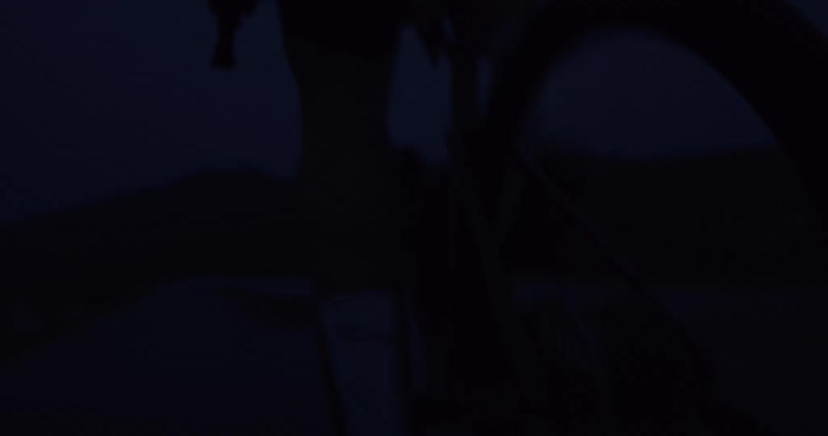 Indecipherable blurry abstract shapes move through an extremely dark setting at night
