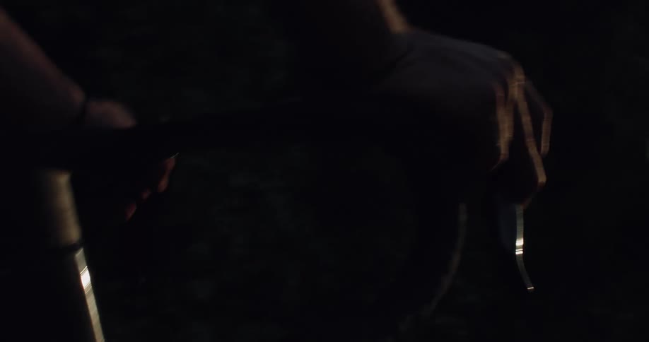 A first-person point-of-view of a cyclist's hands on the handlebars while riding at sunset
