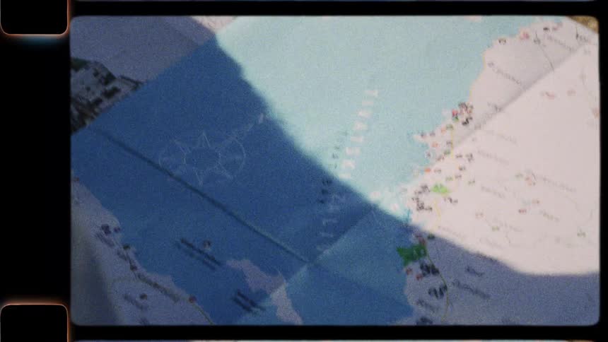Vintage 8mm film captures a traveler's hands unfolding a tourist map of Tivat, Montenegro, while planning their journey outdoors