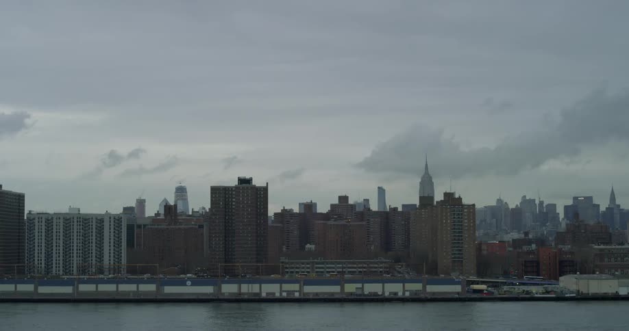 Large city across a river on a cloudy day