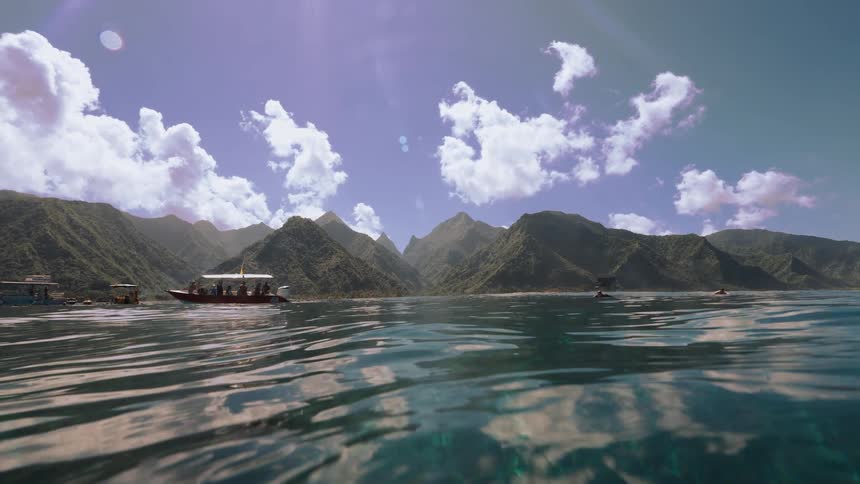 A serene view from the water's surface shows tour boats and a whale's fluke in a stunning tropical bay with mountainous islands