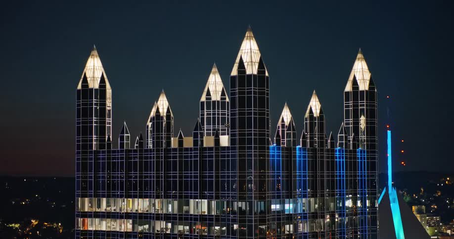 An aerial view of the iconic castle-like PPG Place skyscraper in downtown Pittsburgh illuminated at dusk