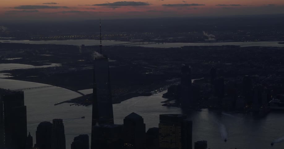 A city skyline and waterway at sunset
