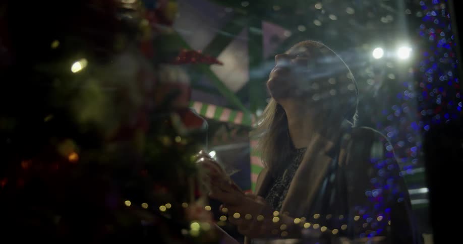 Woman looking at item in a christmas shop
